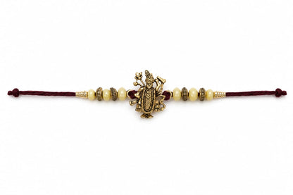 Maa Durga Rakhi Antique Gold Finish Beaded Rakhi Maroon Thread