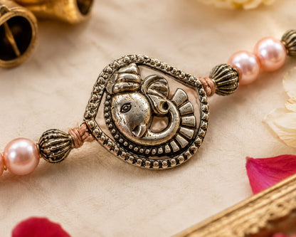 Ganesha Rakhi Antique Silver Finish Pearl Beaded Rakhi Peach
