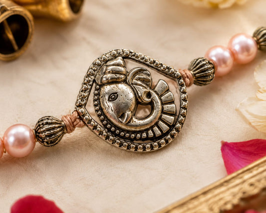 Ganesha Rakhi Antique Silver Finish Pearl Beaded Rakhi Peach